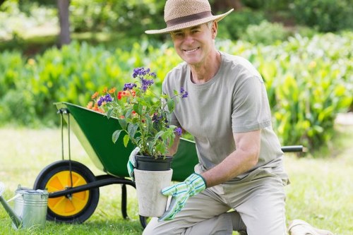 Volunteers and charity partners receiving reusable garden pots and furniture
