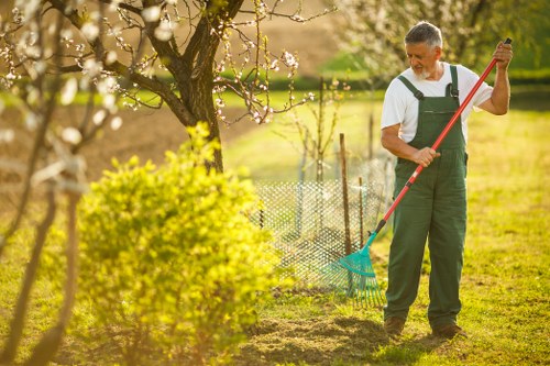 On-site safety signage and tidy tools at a garden project